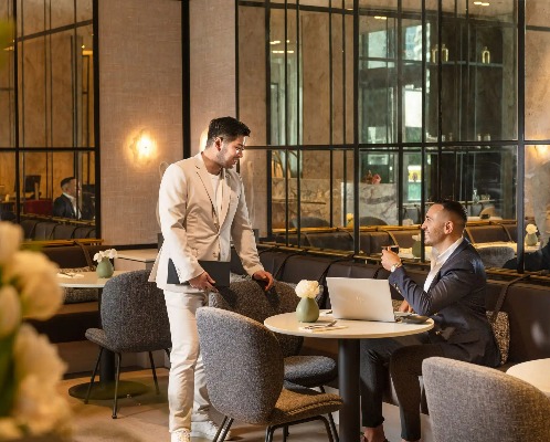 Club lounge with staff serving guests at Dorsett Hotel